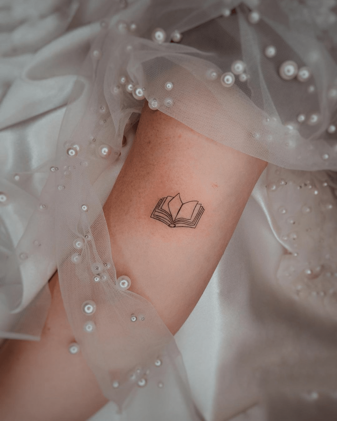 small book arm tattoo for girls