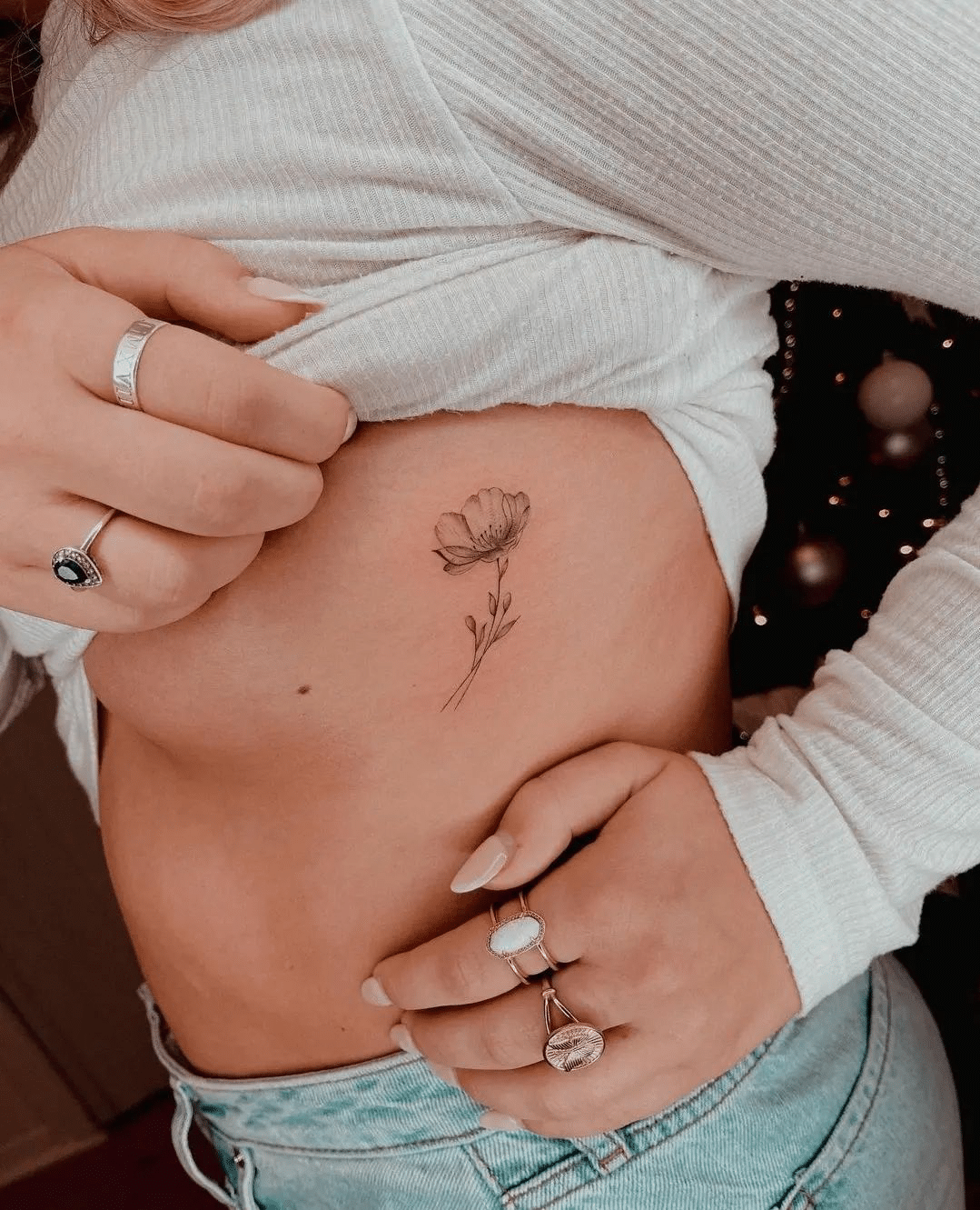 tiny flower rib tattoo for girls