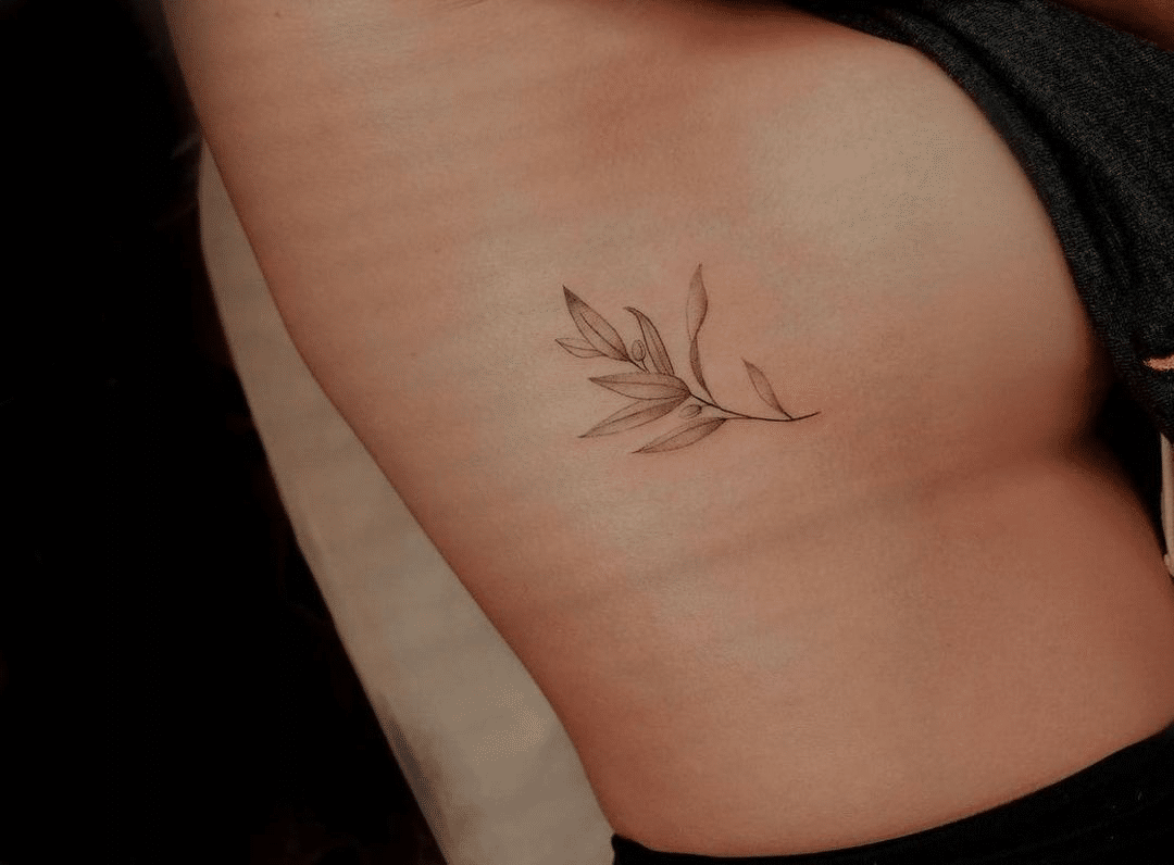 small ornamental rib tattoo for women