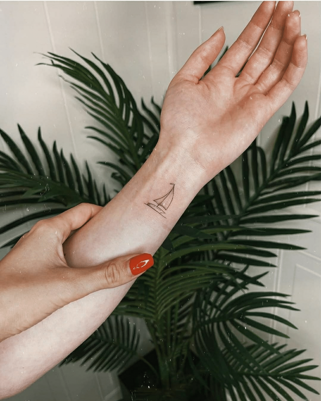 small sailboat tattoo design for women