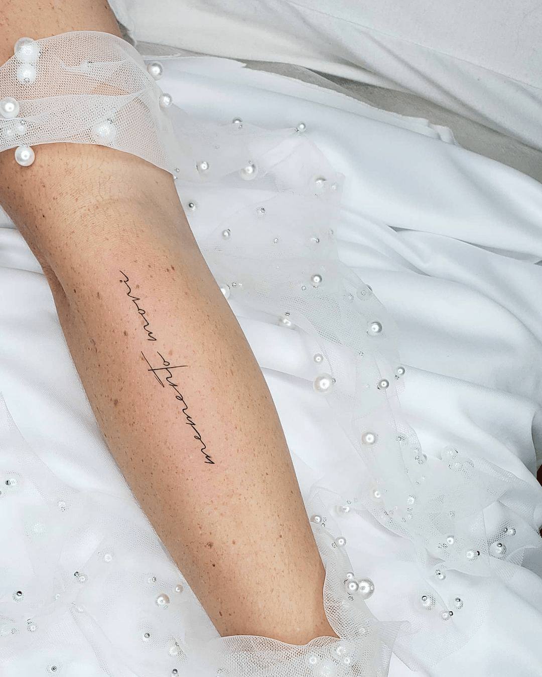small script writing tattoo for women