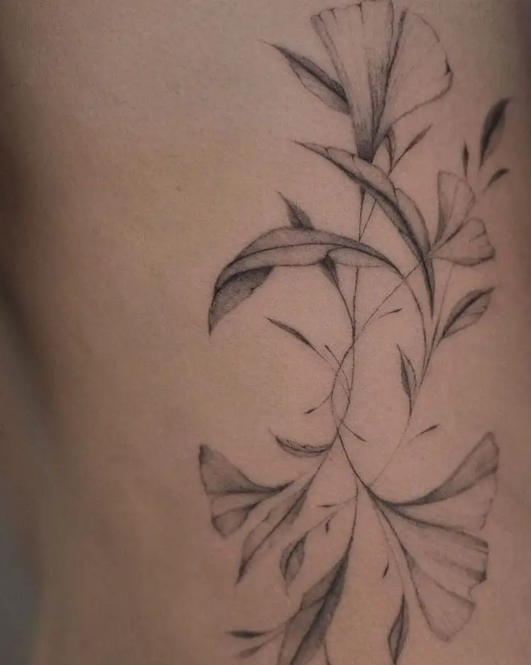 detailed flower tattoos on the ribcage of a woman